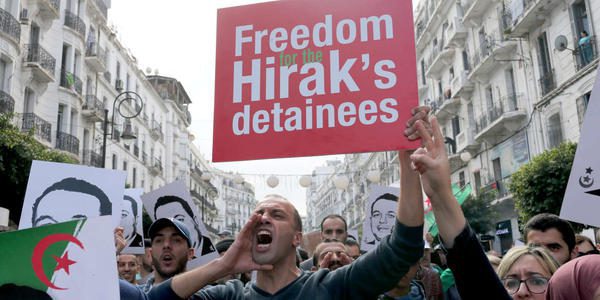 A demonstrator holds a placard during an anti-government rally in Algiers