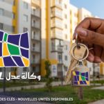 Main tenant une carte Edahabia devant un écran affichant le portail de paiement AADL 3 sur aadl.dz