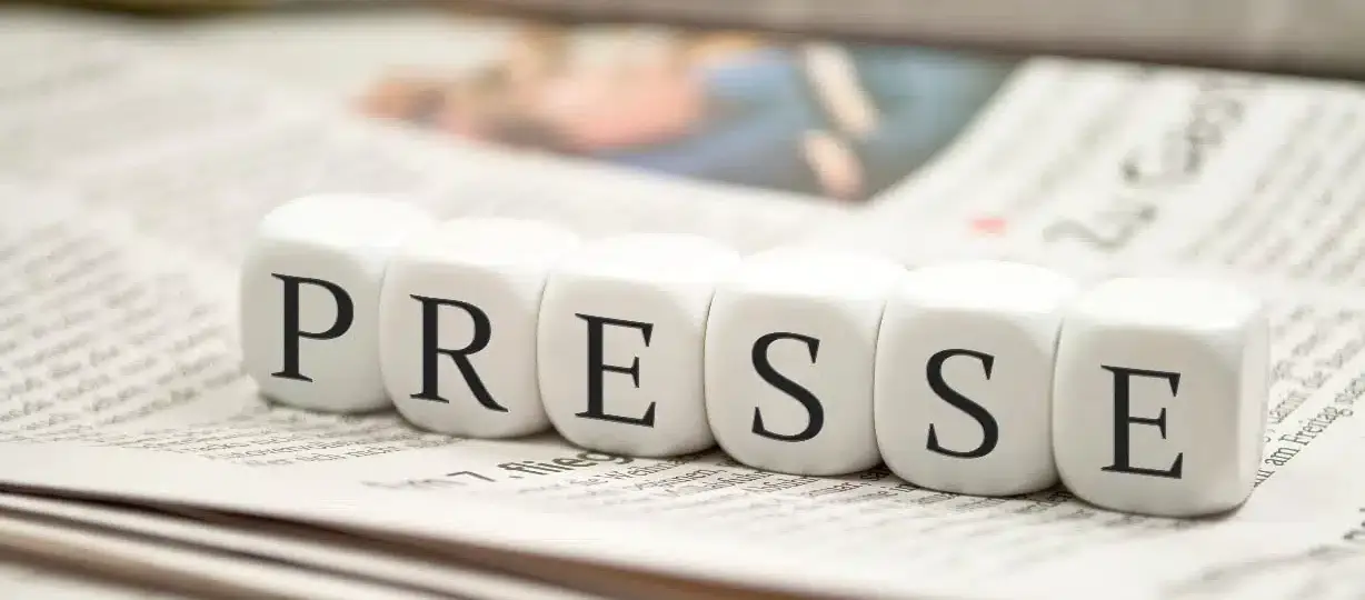 Journaliste algérien tenant un micro devant le siège d'une institution officielle, illustrant les contraintes sur la presse indépendante en Algérie en 2026